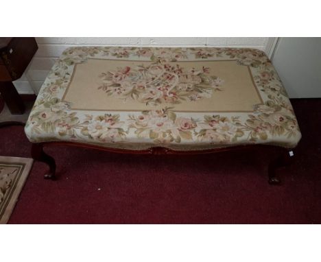 AN ATTRACTIVE RECTANGULAR SERPENTINE SHAPED MAHOGANY STOOL, in the Victorian style, with attractive tapestry seat, raised on 