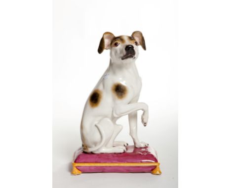 A LARGE MINTON FIGURE, modelled as a spotted Terrier, seated with one paw up, on a pink cushion with tassel feet, date mark p