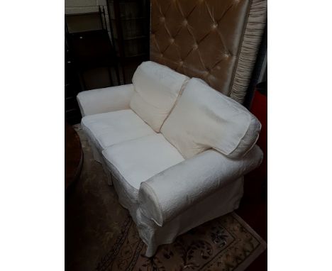 TWO SIMILAR TWO-SEAT SETTEES, each with loose back, cushion and seat, with loose covers, covered in attractive ivory fabric; 