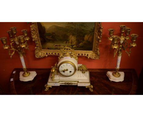 A LATE 19TH CENTURY THREE-PIECE FRENCH WHITE MARBLE AND GILT METAL MANTEL CLOCK GARNITURE, comprising a clock with floral cre