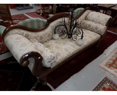 A LATE VICTORIAN DOUBLE ENDED SETTEE, scroll sides and bolster cushions, the shaped and padded back above a padded seat, cove