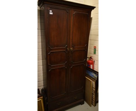 A SMALL MAHOGANY WARDROBE IN THE GEORGE III STYLE, the dentil-moulded cornice above two triple-panel doors and a lower drawer