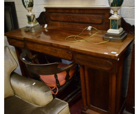 A VICTORIAN MAHOGANY PEDESTAL SIDEBOARD, with three frieze drawers raised on two pedestals each with an arched door and turne