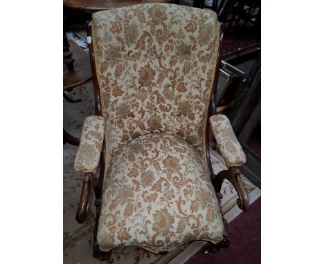 A VICTORIAN WALNUT OPEN ARMCHAIR, with scroll back covered in tapestry-type fabric, the serpentine fronted seat raised on fro