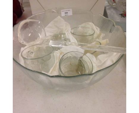 A glass punch bowl, 6 cups and ladle.