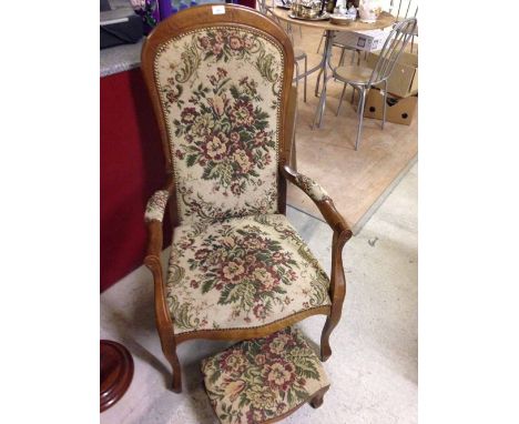 A reproduction Louis XVI style armchair with flower pattern tapestry upholstery and matching footstool