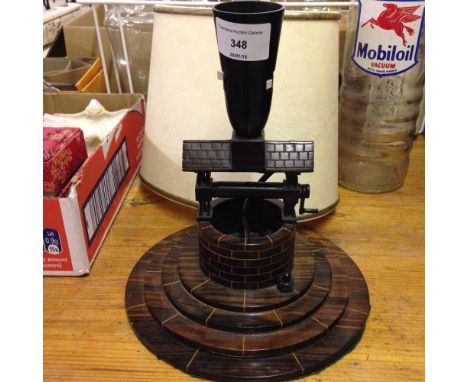 An Art Deco Cocobolo wood carved table lamp in the shape of a well.