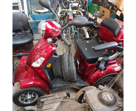 A Green Power electric mobility scooter with key, battery, charger, and a full set of spare wheels. As new, believed to have 