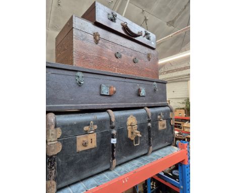 A vintage travel trunk, a carpenter's box and two other wooden boxes.