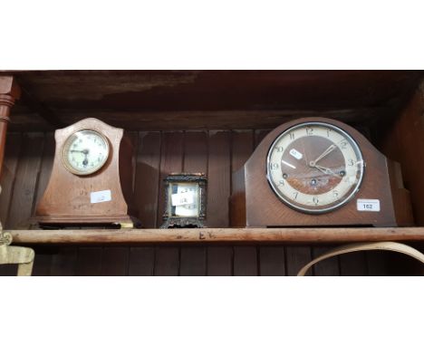 An Enfield mantle clock (pendulum but no key); a mantle clock with pendulum, and a metal cased battery operated carriage cloc