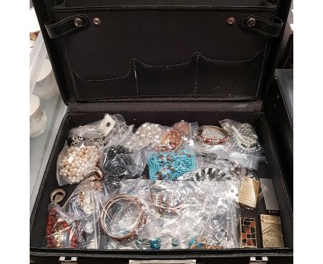 A briefcase of assorted costume jewellery and lighters 