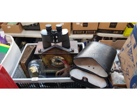A mixed lot comprising two clocks, a cigarette card album, a pair of binoculars and assorted tools.