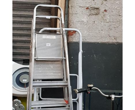 A set of folding ladders, 2 sets of aluminium steps, and a set of steel step ladders
