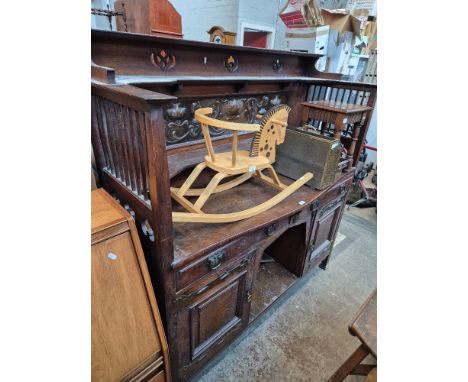 An Arts &amp; Crafts oak sideboard by Shapland and Petter, with copper panel to back and copper strap hinges, the locks marke