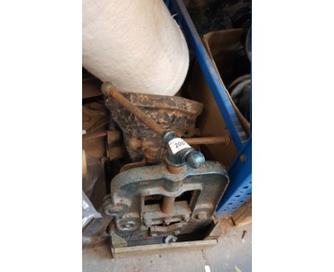 2 bench pipe vices, a cast metal gutter collector, and some horse shoes
