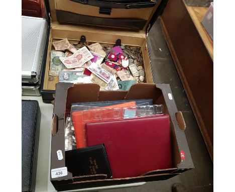 A briefcase of assorted world coins, banknotes, sets and a box of empty coin folders.