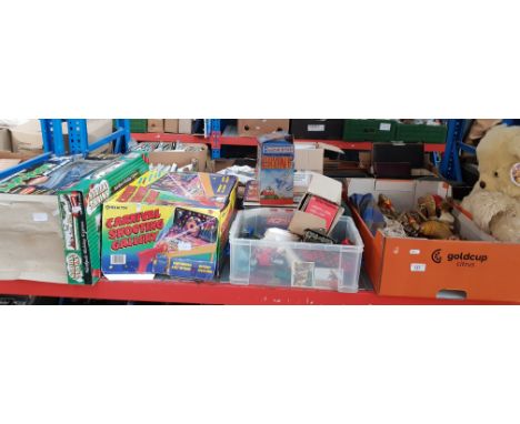 A shelf of childrens games and toys including Carnival Shooting Gallery, remote controlled racing car, Viewmaster with Disney