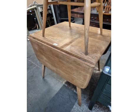 A 1960s Ercol light elm drop leaf dining table, model 383.
