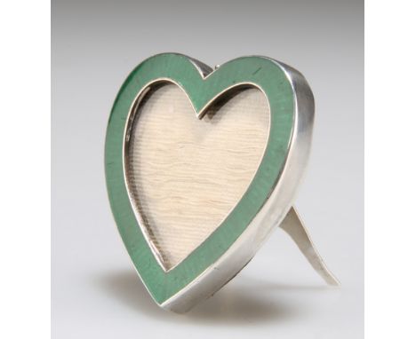 A LATE VICTORIAN SILVER AND ENAMEL PHOTOGRAPH FRAME,&nbsp;Birmingham 1898, the small frame heart-shaped, picked-out with gree