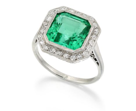 AN ART DECO COLOMBIAN EMERALD AND DIAMOND CLUSTER RING, an octagonal-cut emerald within a conforming milgrain border of eight