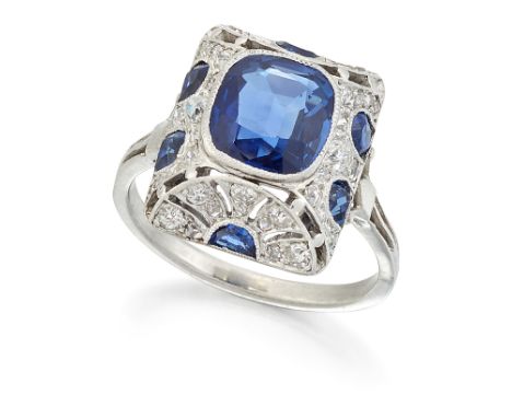 AN ART DECO SAPPHIRE AND DIAMOND RING, a cushion-cut sapphire within a milgrain and pierced sugar-loaf frame, set with calibr