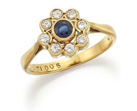 AN 18 CARAT GOLD SAPPHIRE AND DIAMOND CLUSTER RING, a round-cut sapphire within a border of round brilliant-cut diamonds, to 