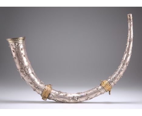 A LARGE CONTINENTAL WHITE-METAL HORN, 19TH CENTURY, decorated in relief with putti, masks, cranes and foliage. 41.5cmThe abse