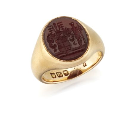 AN 18 CARAT GOLD CARNELIAN INTAGLIO SIGNET RING, the oval intaglio carved with a crest in a rub-over setting to the tapering 