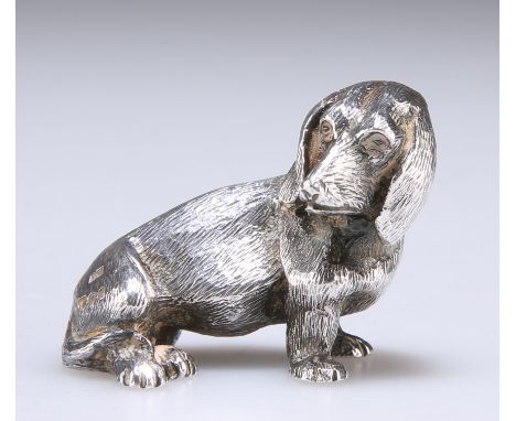 AN ELIZABETH II SILVER NOVELTY MODEL OF A DOG,&nbsp;by Mappin &amp; Webb Ltd, London 1973, cast as a seated dachshund with he