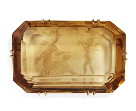 A CITRINE REVERSE INTAGLIO BROOCH, an octagonal-cut citrine carved depicting Psyche seated with a ewer and Cupid playing a do