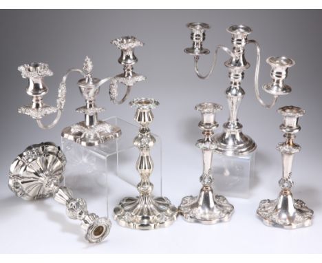 A GROUP OF SILVER-PLATED CANDLESTICKS AND CANDELABRA, comprising two pairs of 19th Century Rococo Revival candlesticks, three