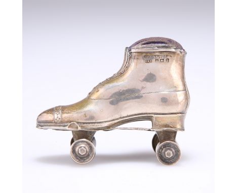AN EDWARD VII SILVER SKATE NOVELTY PIN CUSHION,&nbsp;by Crisford &amp; Norris Ltd, Birmingham 1908, as a lady's shoe on a rol