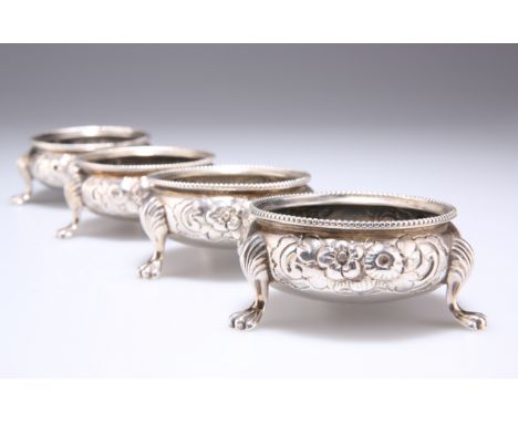 A SET OF FOUR VICTORIAN SILVER SALTS,&nbsp;by Robert Harper, London 1866, circular, repousse with scrolling flowers and folia