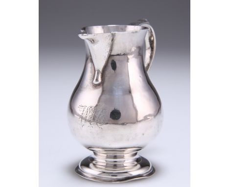 A GEORGE II SILVER PITCHER CREAM JUG,&nbsp;by Thomas Rush, London 1743, of baluster form, with S-scroll handle, raised on a c