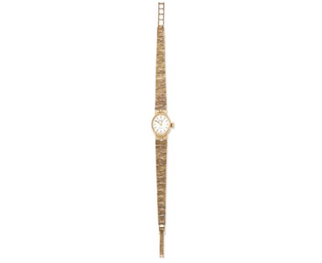 LADYS 9 CARAT GOLD ROTARY BRACELET WATCH, oval silver dial with baton index and plain hands, oval case 17 x 14.5mm with integ