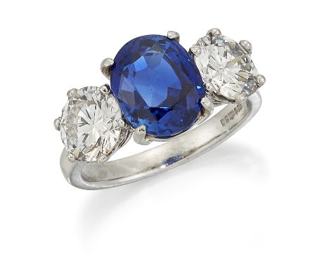 A PLATINUM BURMA SAPPHIRE AND DIAMOND RING, a cushion-cut sapphire between two round brilliant-cut diamonds in claw settings,