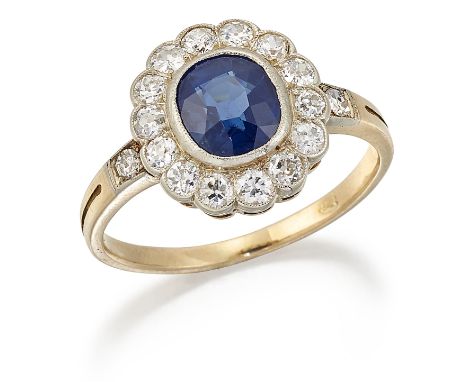 A SAPPHIRE AND DIAMOND CLUSTER RING, a cushion-cut sapphire within a border of milgrain set old-cut diamonds, to eight-cut di