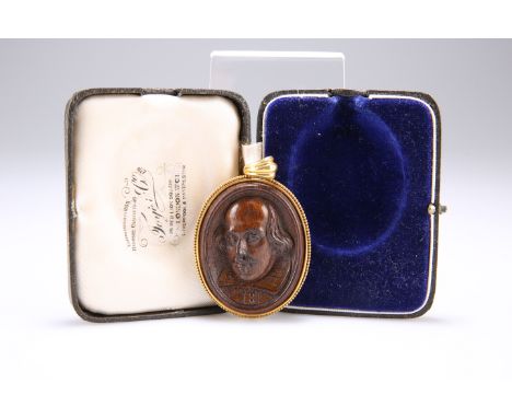A CARVED MULBERRY WOOD DOUBLE CAMEO PENDANT, carved depicting a portrait of William Shakespeare and a wreath of oak verso, wi