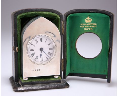 AN EDWARDIAN SILVER TRAVELLING CLOCK,&nbsp;by&nbsp;Henry Clifford Davis, Birmingham 1906, the lancet shaped case with bun fee