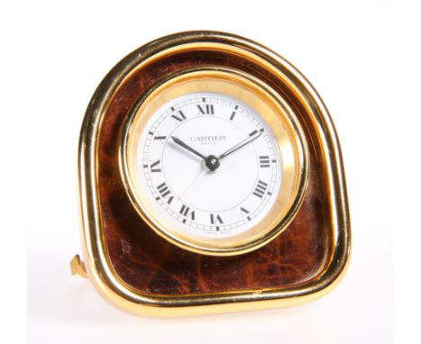 A CARTIER YELLOW-METAL STRUT CLOCK, the arch-top case housing a circular white dial, signed 'Cartier Paris', the movement wit