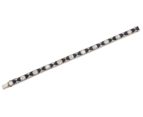 AN ART DECO SAPPHIRE AND DIAMOND BRACELET, pairs of calibré-cut sapphires spaced by diamond accents, alternating with old Eur