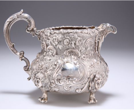 A VICTORIAN SILVER JUG,&nbsp;probably by George John Richards, London 1849, squat baluster form, heavily chased with all-over