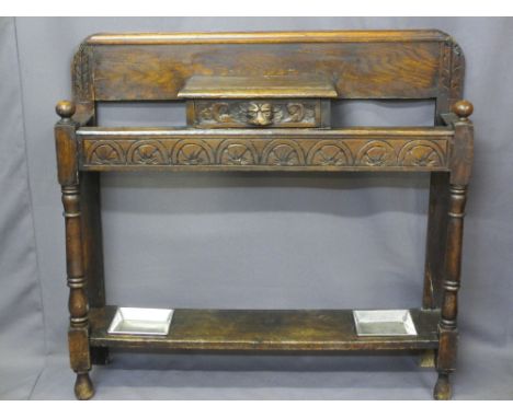 CARVED OAK HALL STICK STAND, reduced height with lion mask central drawer and turned front supports with dual drip trays, 95c