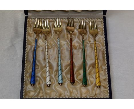 A cased set of six Danish silver gilt and enamel pastry forks of various colours, marked Ela Denmark Sterling 925S
Condition 