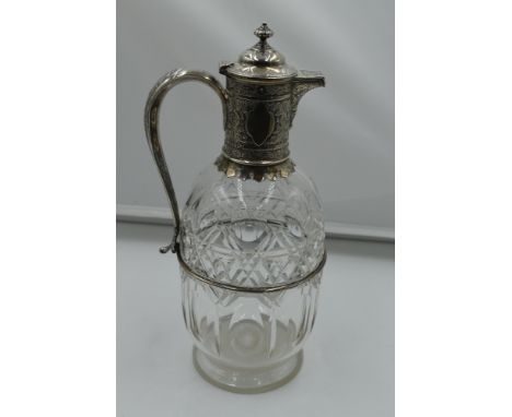 A Victorian cut glass and silver claret jug having domed hinged lid, scroll handle with acanthus leaf decoration and plain ca