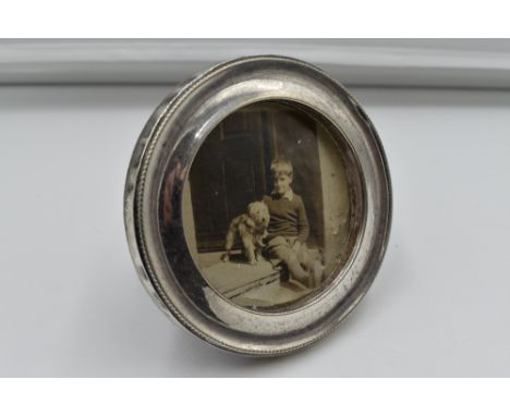A small photograph frame of circular form having wooden easel back, Birmingham 1918, makers mark worn
Condition Report&nbsp; 