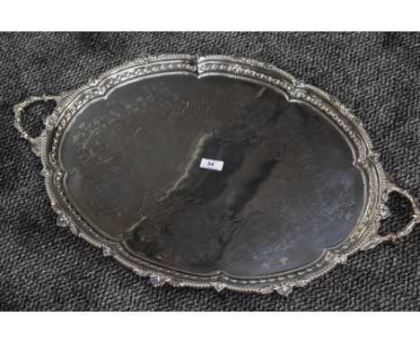 A Victorian silver butler's tray of oval form having moulded handles, moulded decoration to raised rim and engraved decoratio
