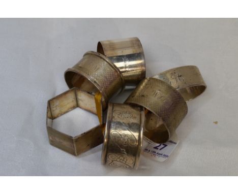 Five HM silver napkin rings of various forms, all having monograms, and a similar white metal napkin ring
Weight Approx: x5 i