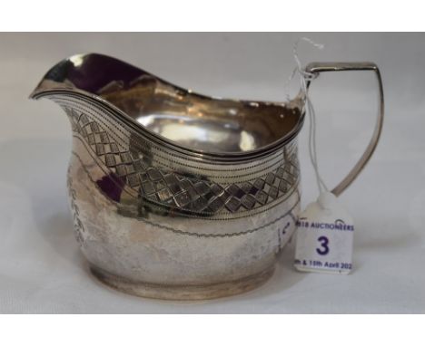 A Georgian silver cream jug of helmet form having bright cut decoration and monogram to cartouche, London 1811, Peter &amp; W