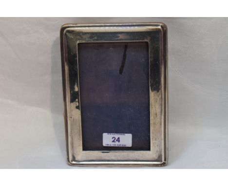 A silver photograph frame of plain rectangular form having wooden easel stand, London 1922, A &amp; J Zimmerman
Condition Rep